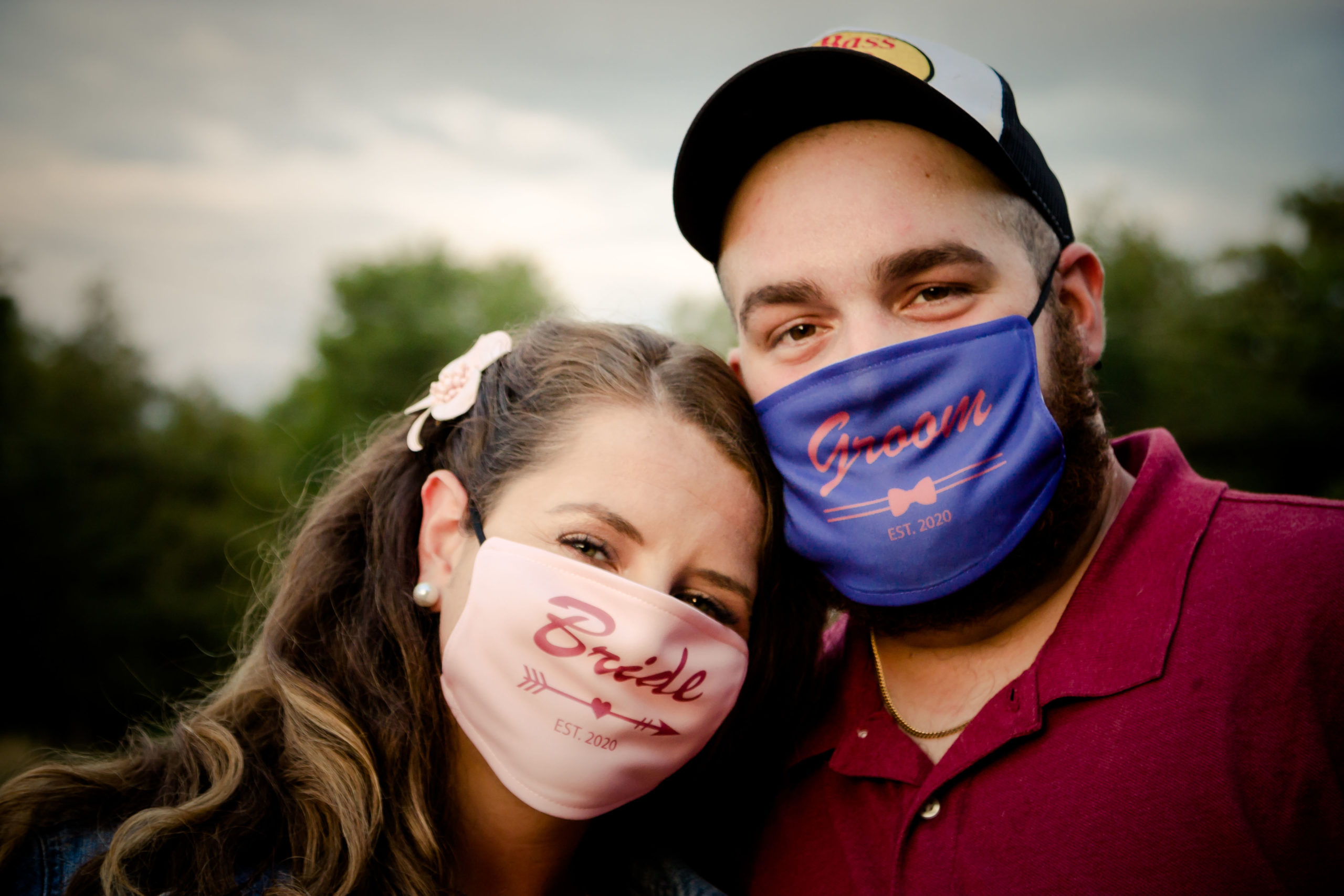 Engaged couple wearing covid masks