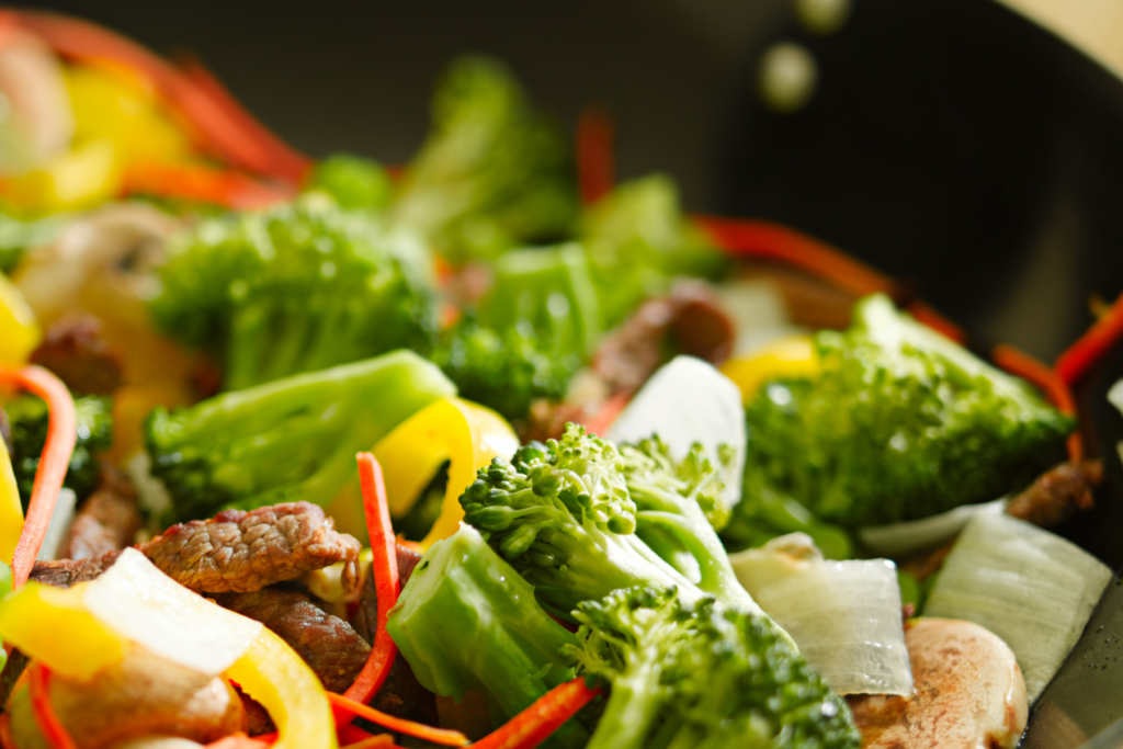 Vendor meal served to wedding photographer during reception dinner — nutritious stir fry with vegetables and beef